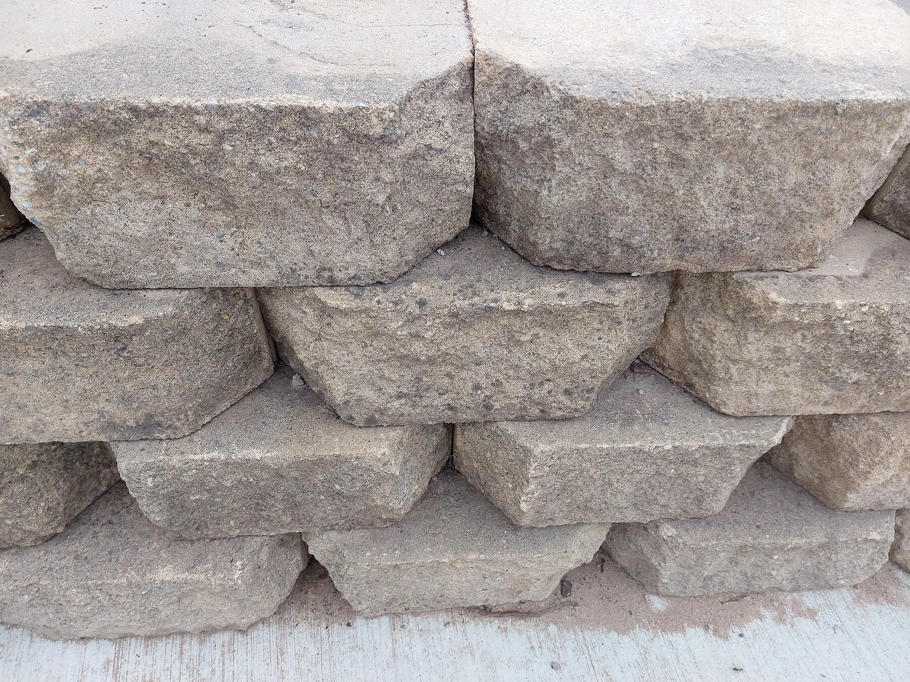 Segmental concrete retaining wall blocks stacked with a visible setback